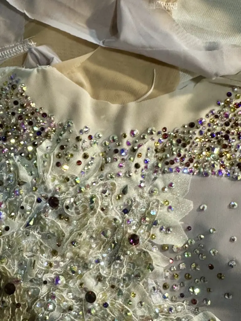 Rhinestone being applied to a custom lyrical costume front during the creation and production step by Sewn 2 Dance