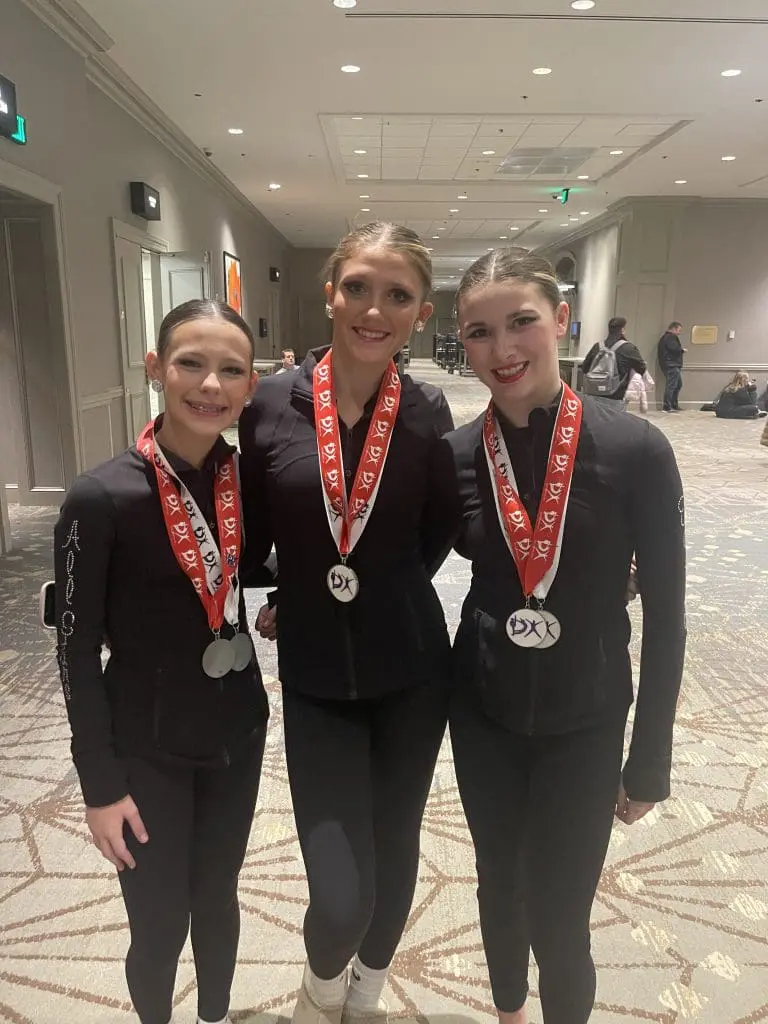 3 competitive dancers with metals a