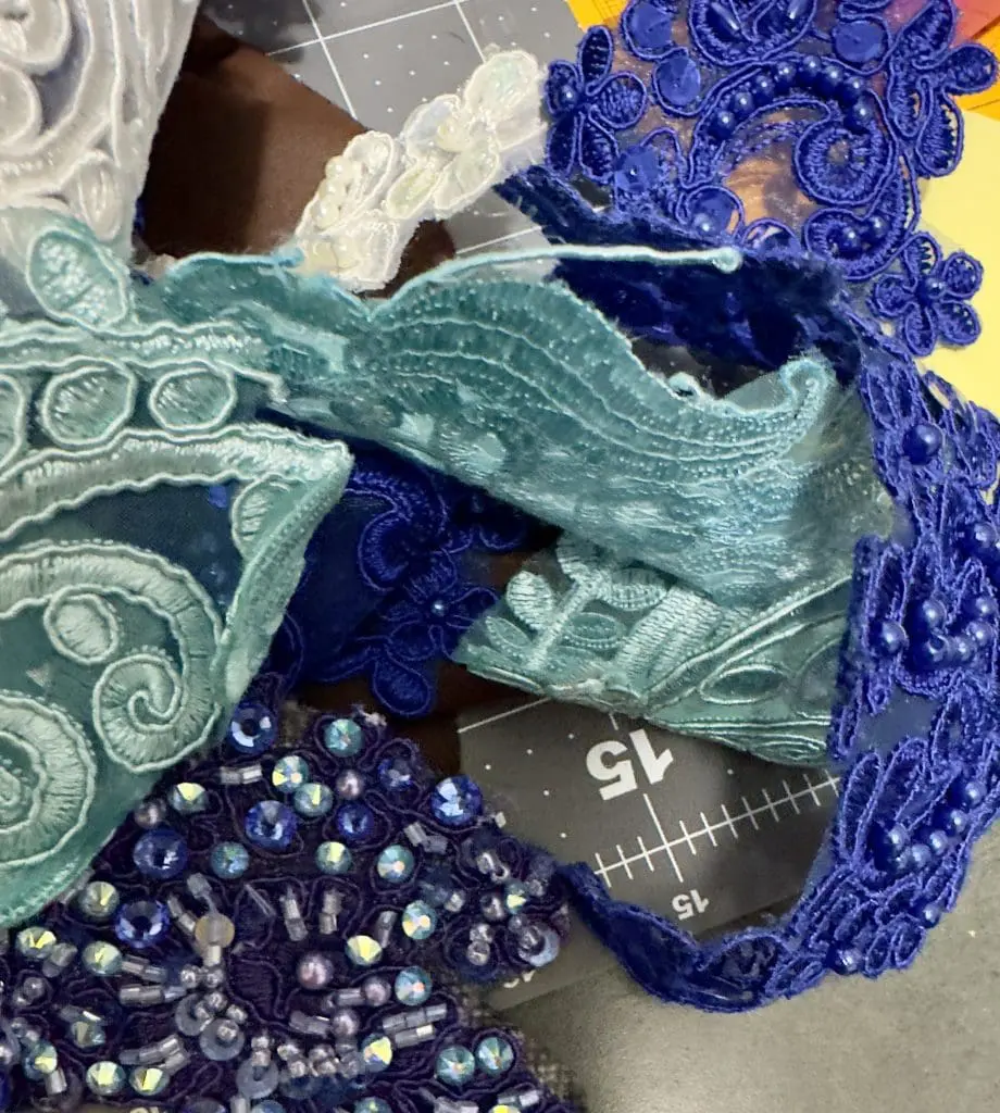 Several different samples of Lace trim, in different shaded hand dyed by Sewn 2 Dance some beaded and rhinestones representing choices in the design process in step 2