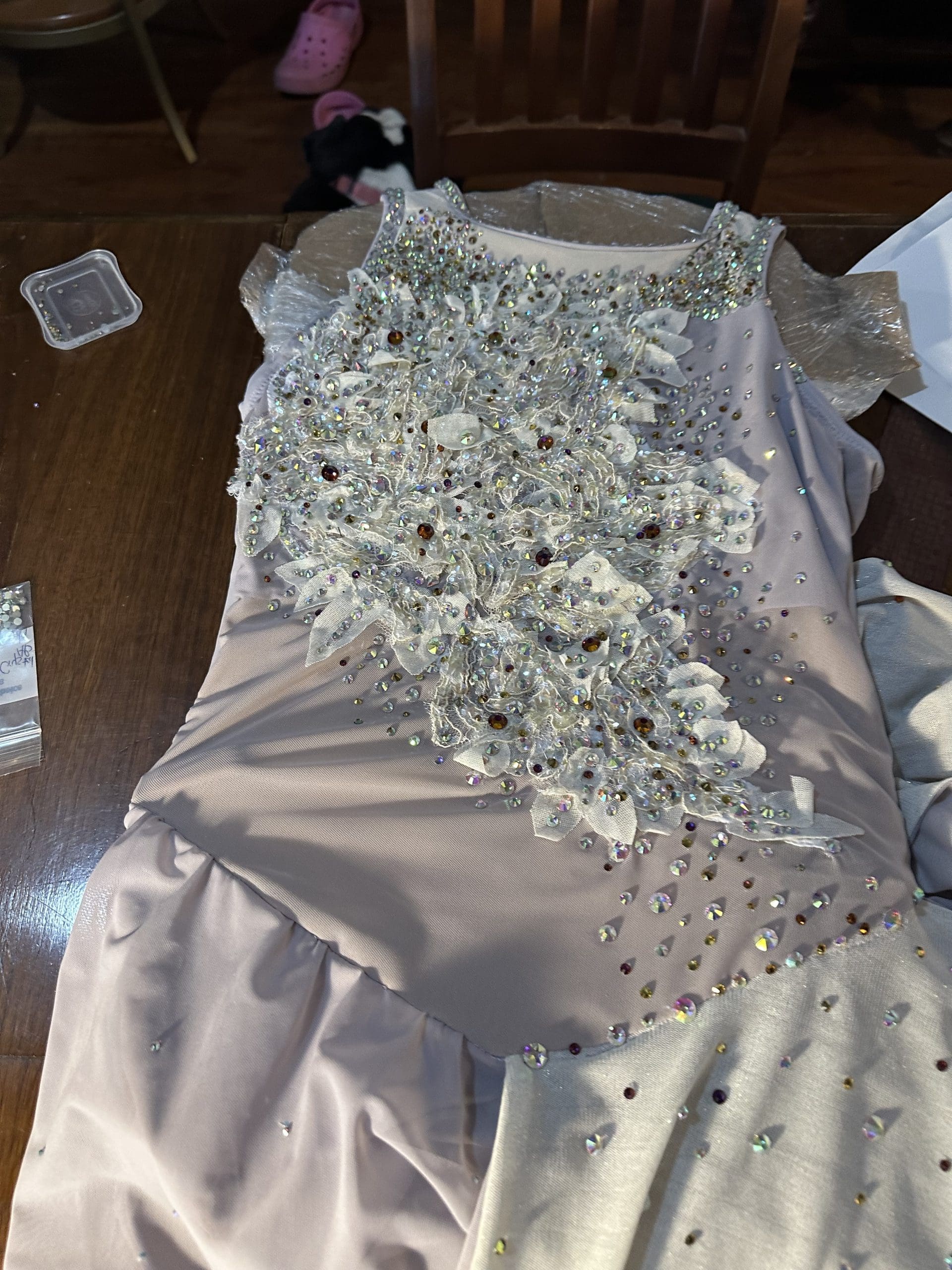 Applying rhinestones to a custom dancewear from Sewn 2 Dance