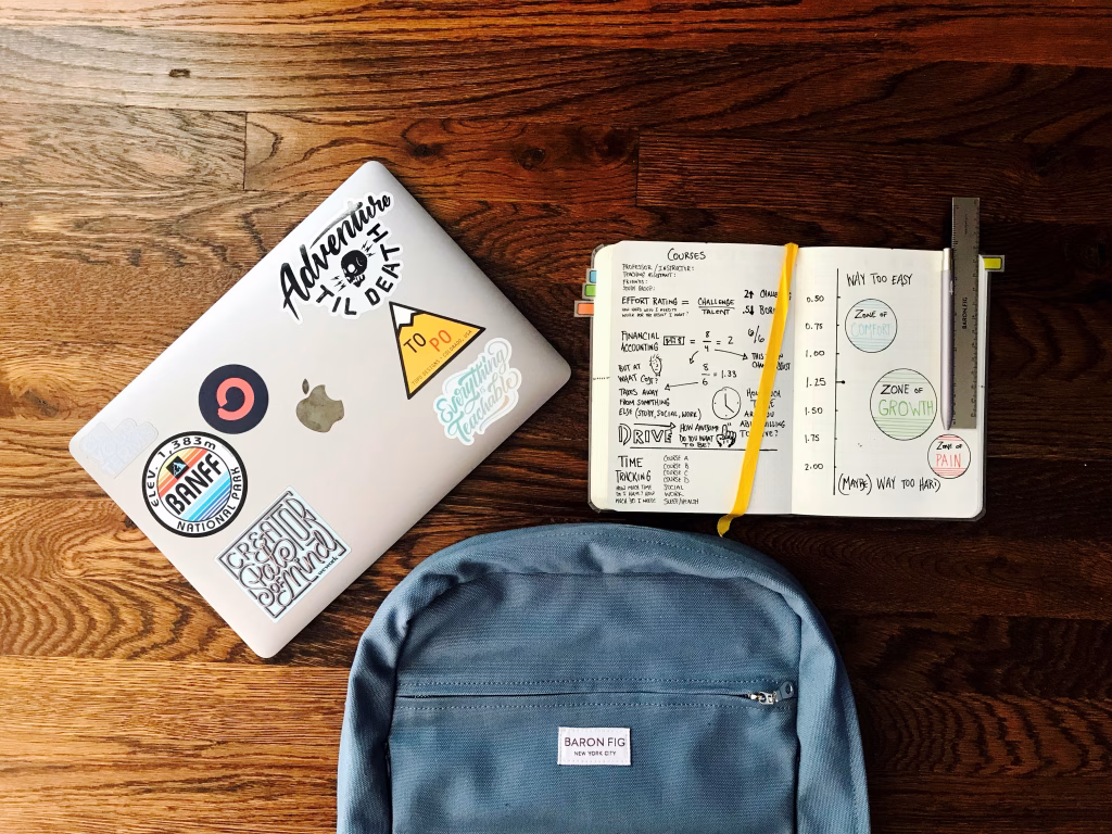 Design Consultation Book appointment form image of computer, notebook and backpack on a desk